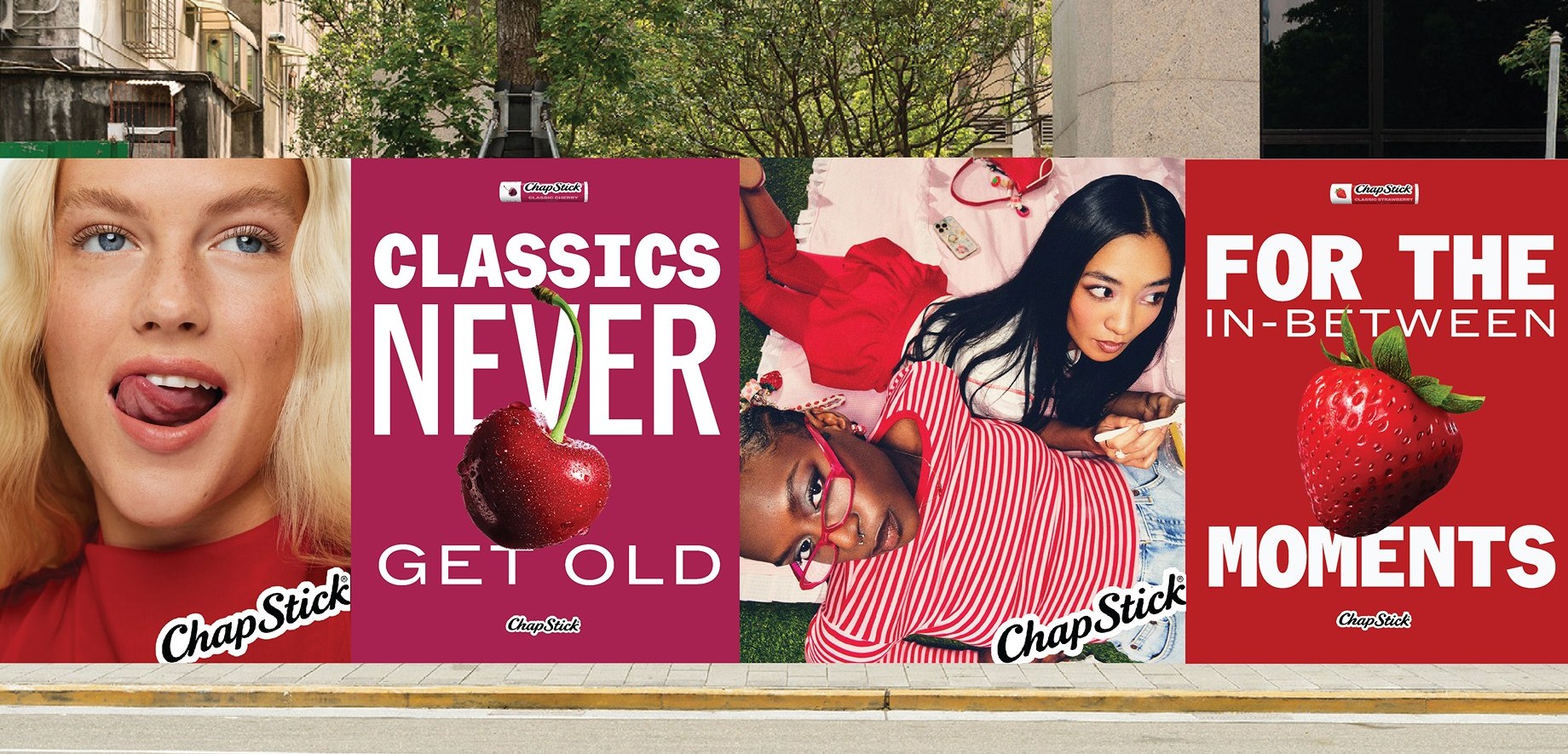 Street-level mockup of four ChapStick posters on a wall, including "Classics never get old" with a cherry and a strawberry poster
