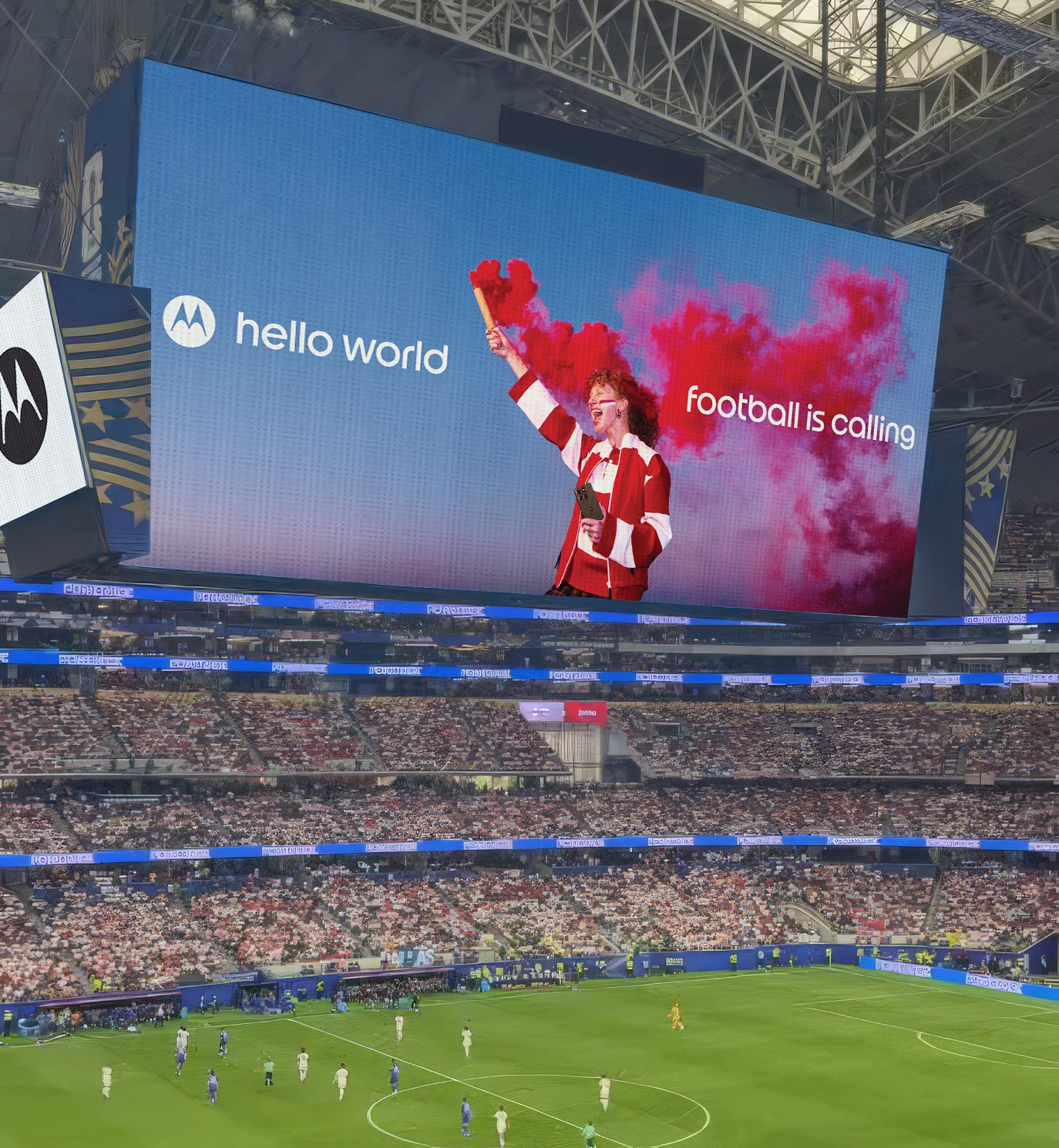 Stadium jumbotron with a fan in red and white raising a red flare, "hello world" and "football is calling"